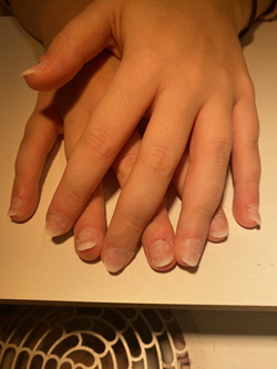 The plastic nail extensions are filed to the shape and length of natural nails